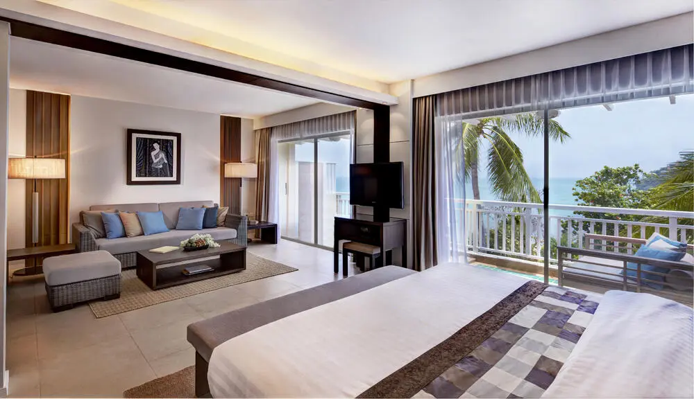 A hotel suite with a sea view at Cape Panwa Hotel