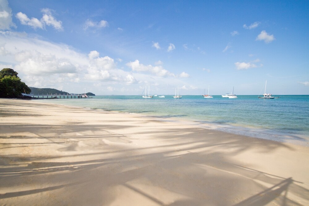 Boats off the shore of Cape Panwa Beach in Phuket