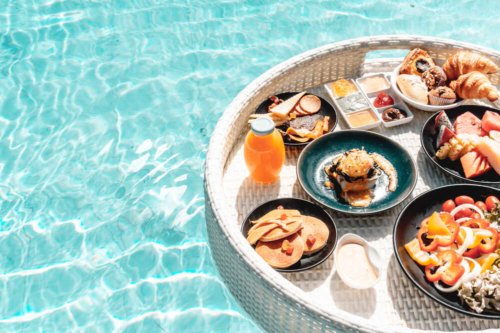 A floating breakfast tray inside a pool
